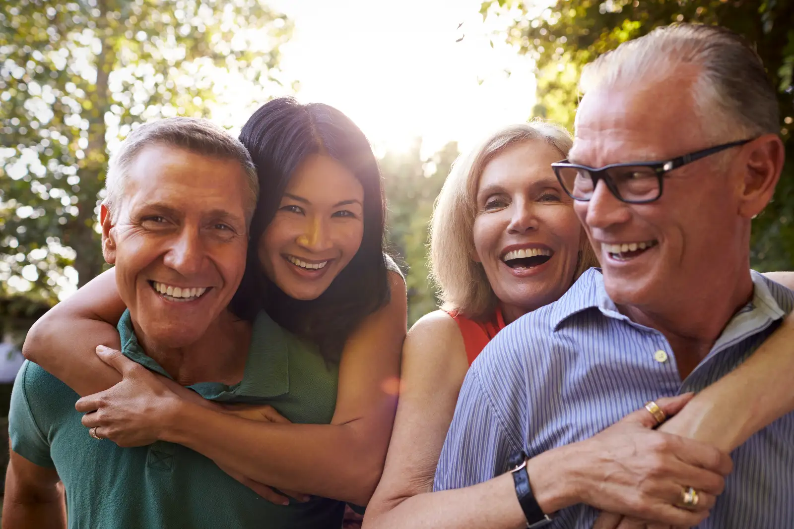 Two elderly couples smiling